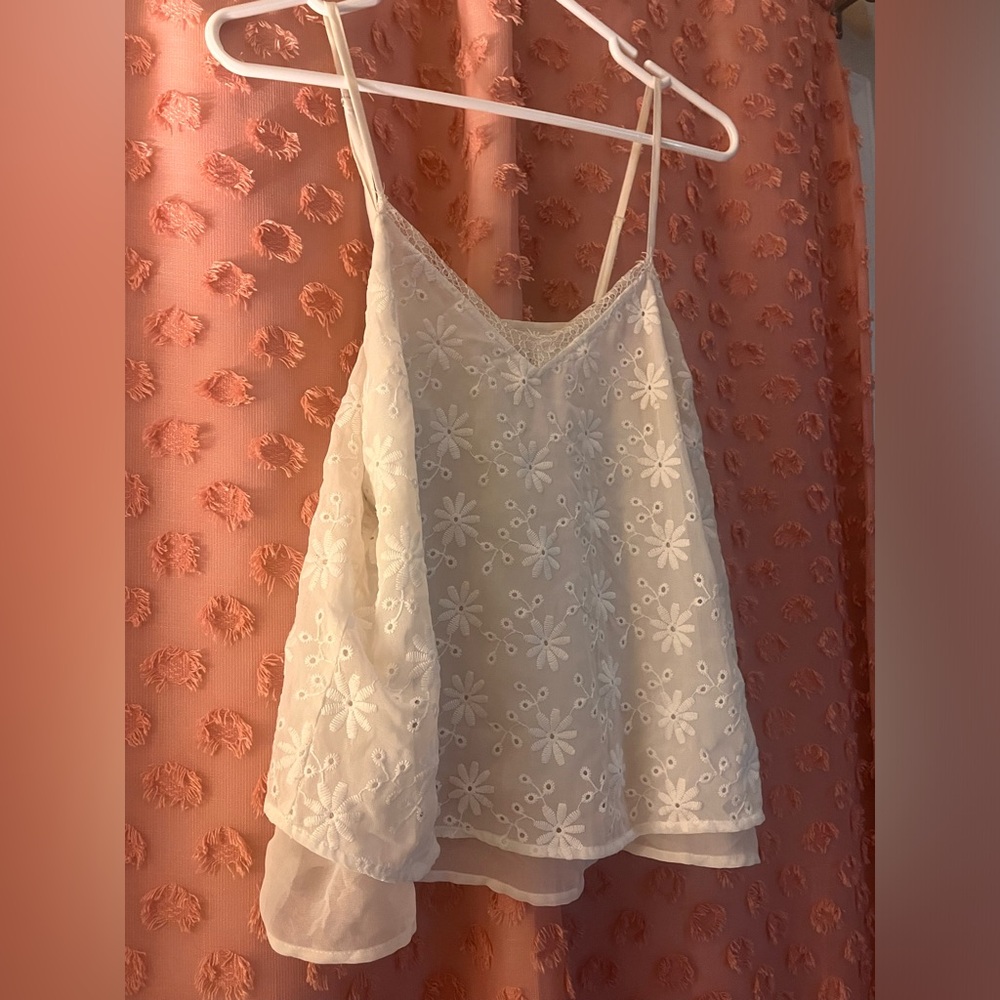 Small, white, eyelet lace spaghetti strap tank top.